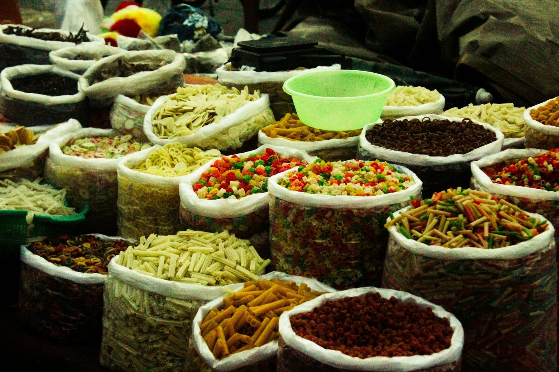 Open sacks of grain, spices, and food staples at a market