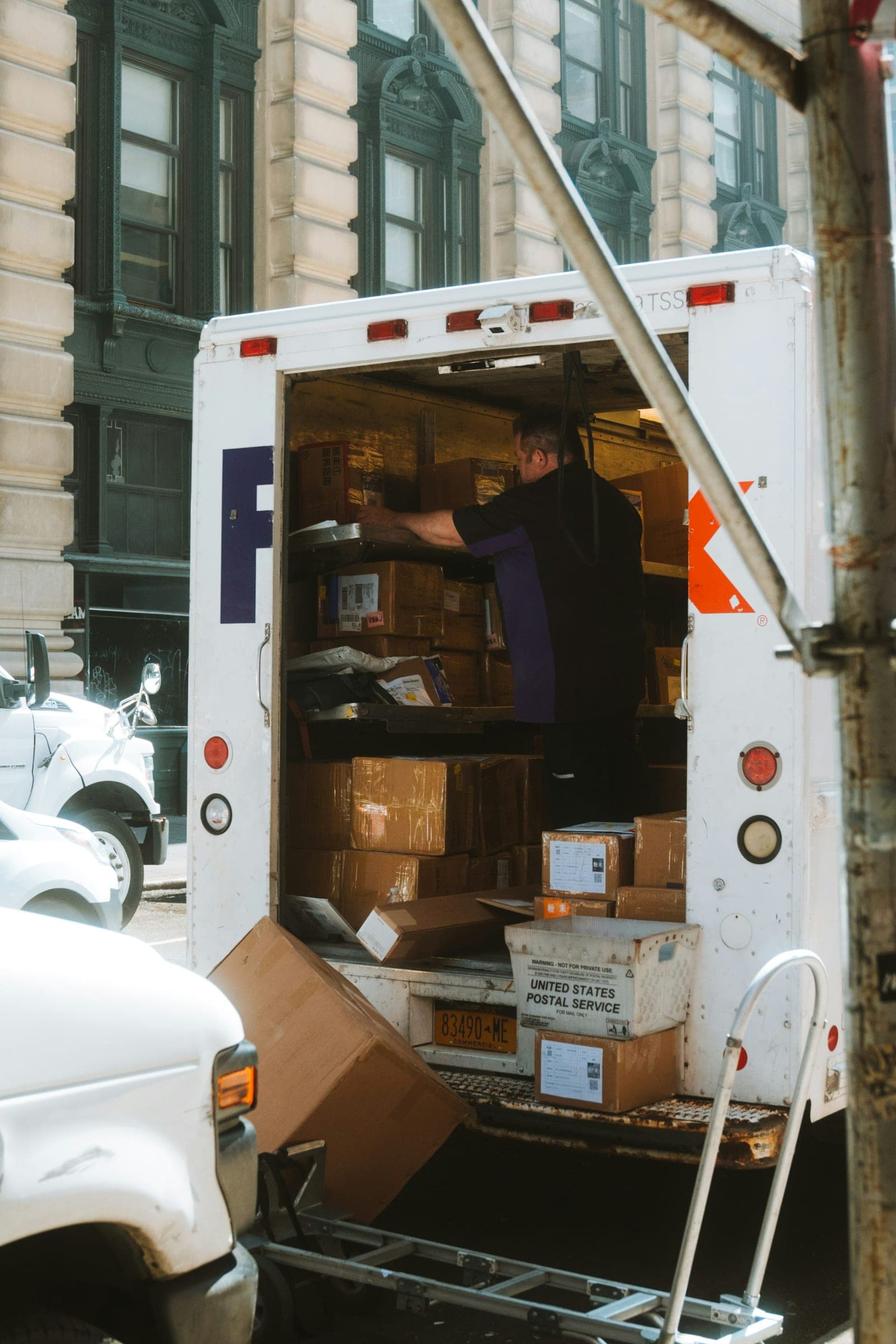 A man loading boxes into the back of a moving truck