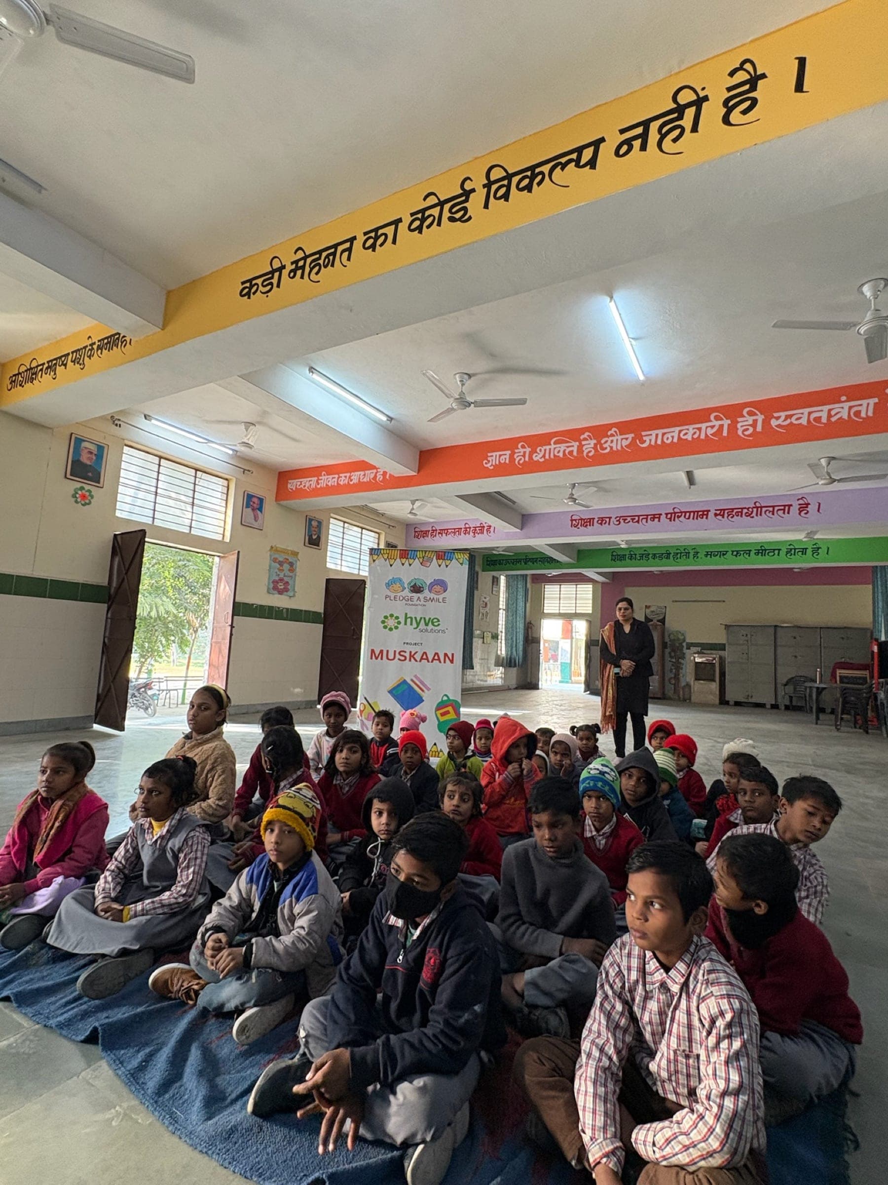 Volunteers distributing REVORD shoe boxes to schoolchildren in classroom