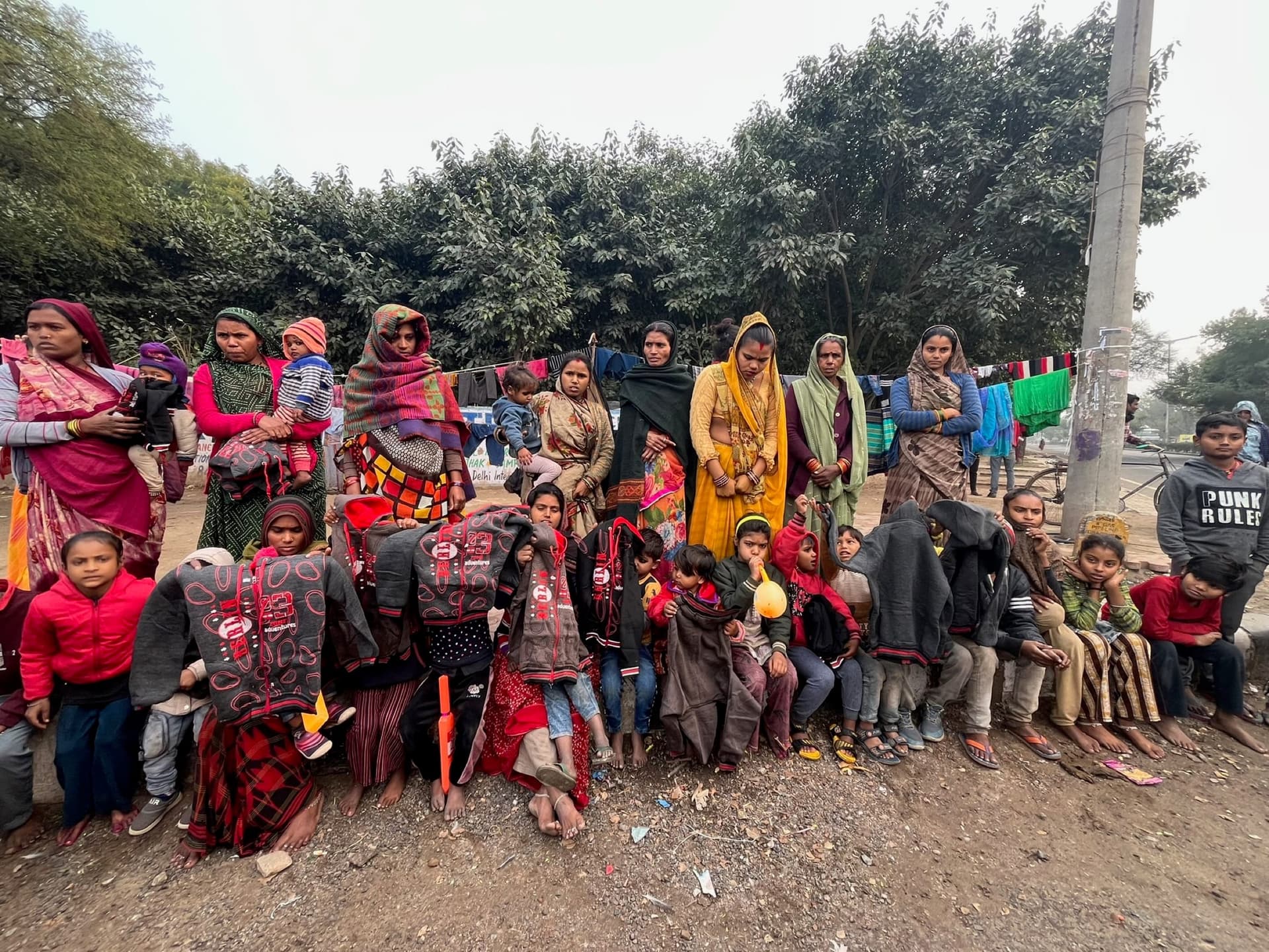 Wide shot of a blanket-wrapped community with the crowd spread edge to edge.
