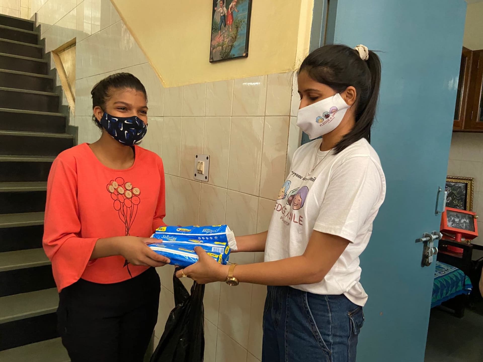 Girls with their Noori hygiene kits at a distribution session